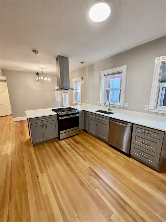 24 Howes Street, Unit 3 Boston, MA 02125 - Photo 2 of 15 a kitchen with stainless steel appliances granite countertop a sink and a stove top oven