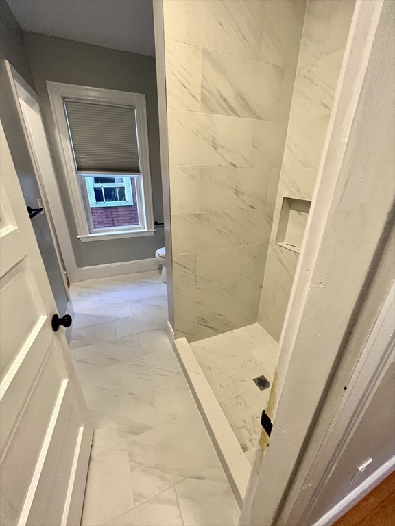 24 Howes Street, Unit 3 Boston, MA 02125 - Photo 6 of 15 a bathroom with a tub and shower