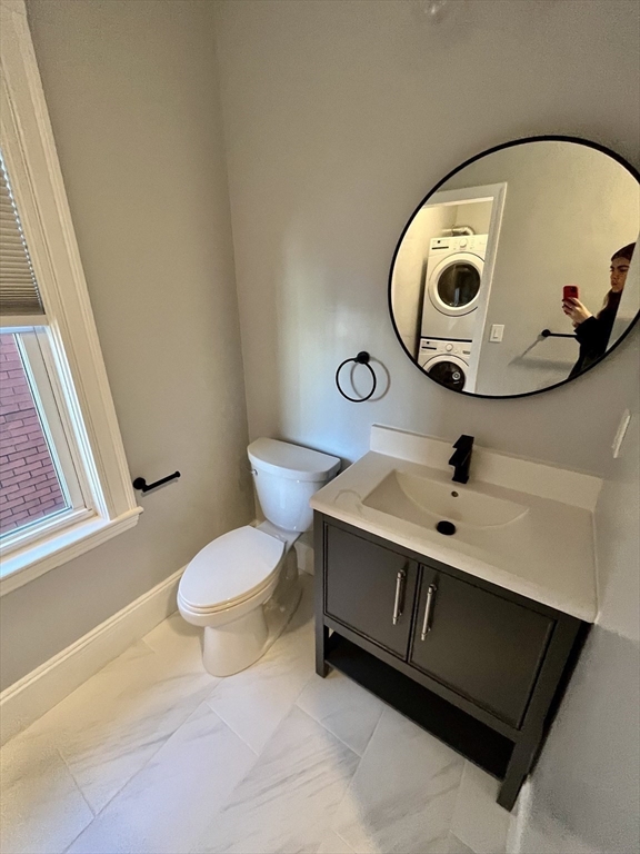 24 Howes Street, Unit 3 Boston, MA 02125 - Photo 10 of 15 a bathroom with a sink mirror and toilet