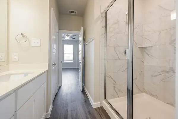 a white toilet sitting next to a bath tub