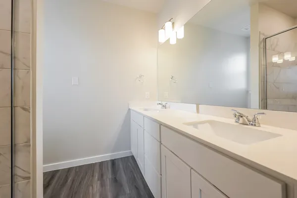 a bathroom with a toilet sink vanity tub and shower