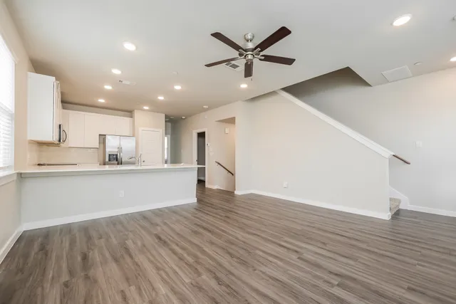 a kitchen with kitchen island a refrigerator sink and stove