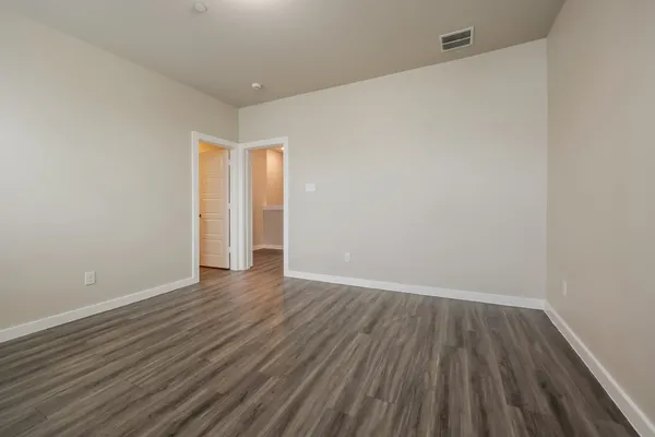 a bedroom with a bed and flat screen tv