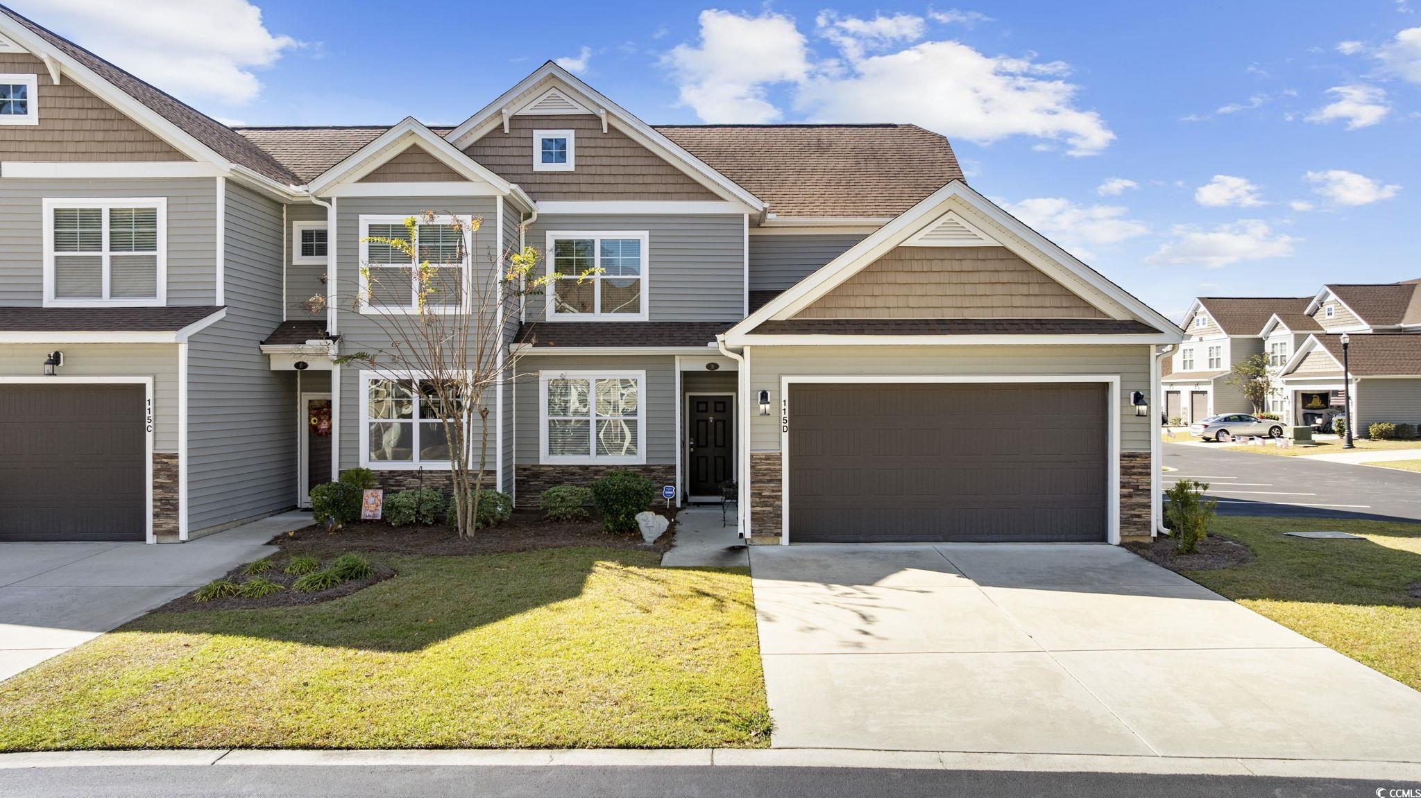 Craftsman-style house with stone siding, a front lawn, roof with shingles, and concrete driveway
