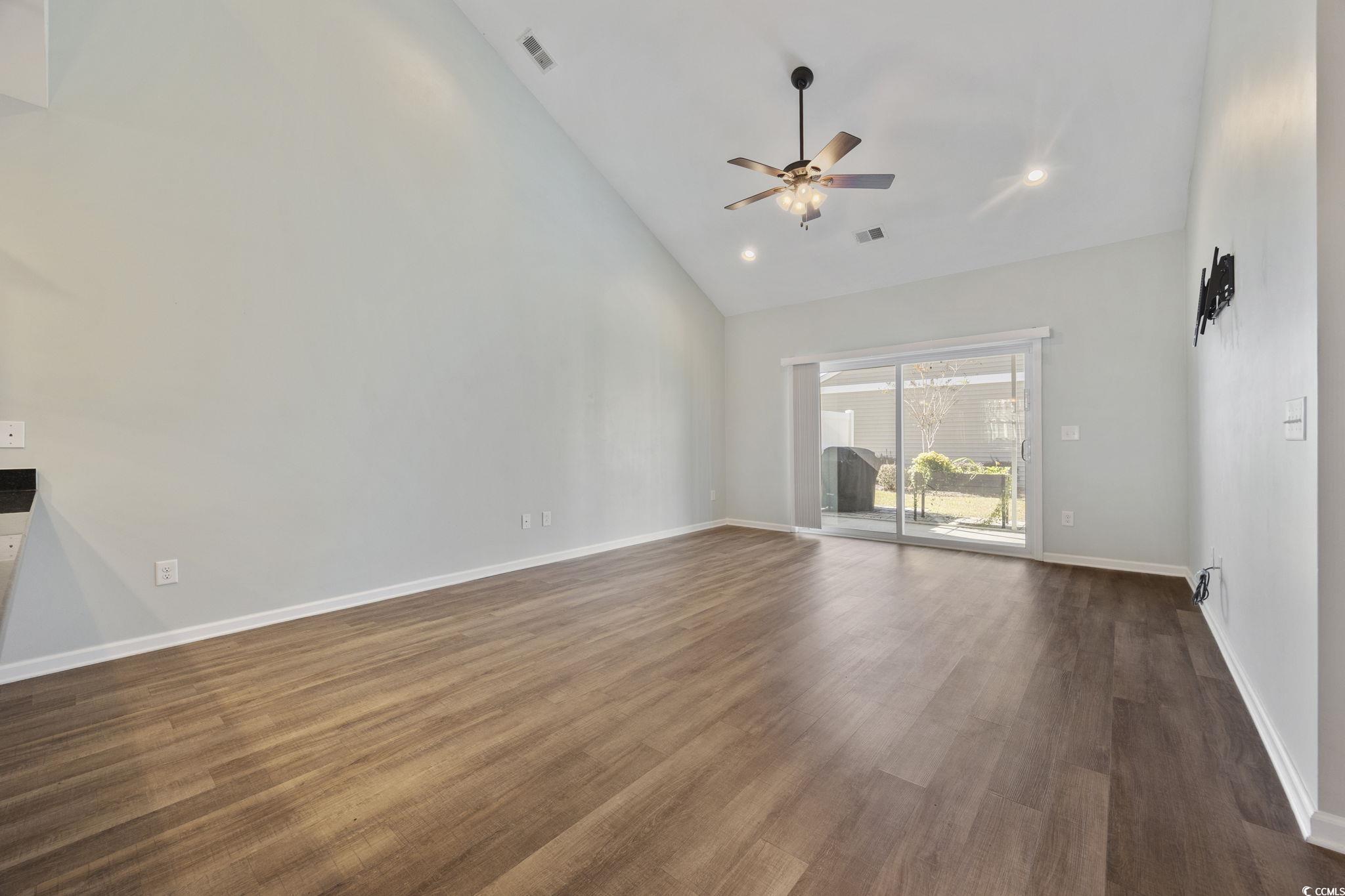 115 Machrie Loop, Unit D Myrtle Beach, SC 29588 - Photo 11 of 40 Unfurnished living room featuring high vaulted ceiling, dark wood-type flooring, recessed lighting, and a ceiling fan