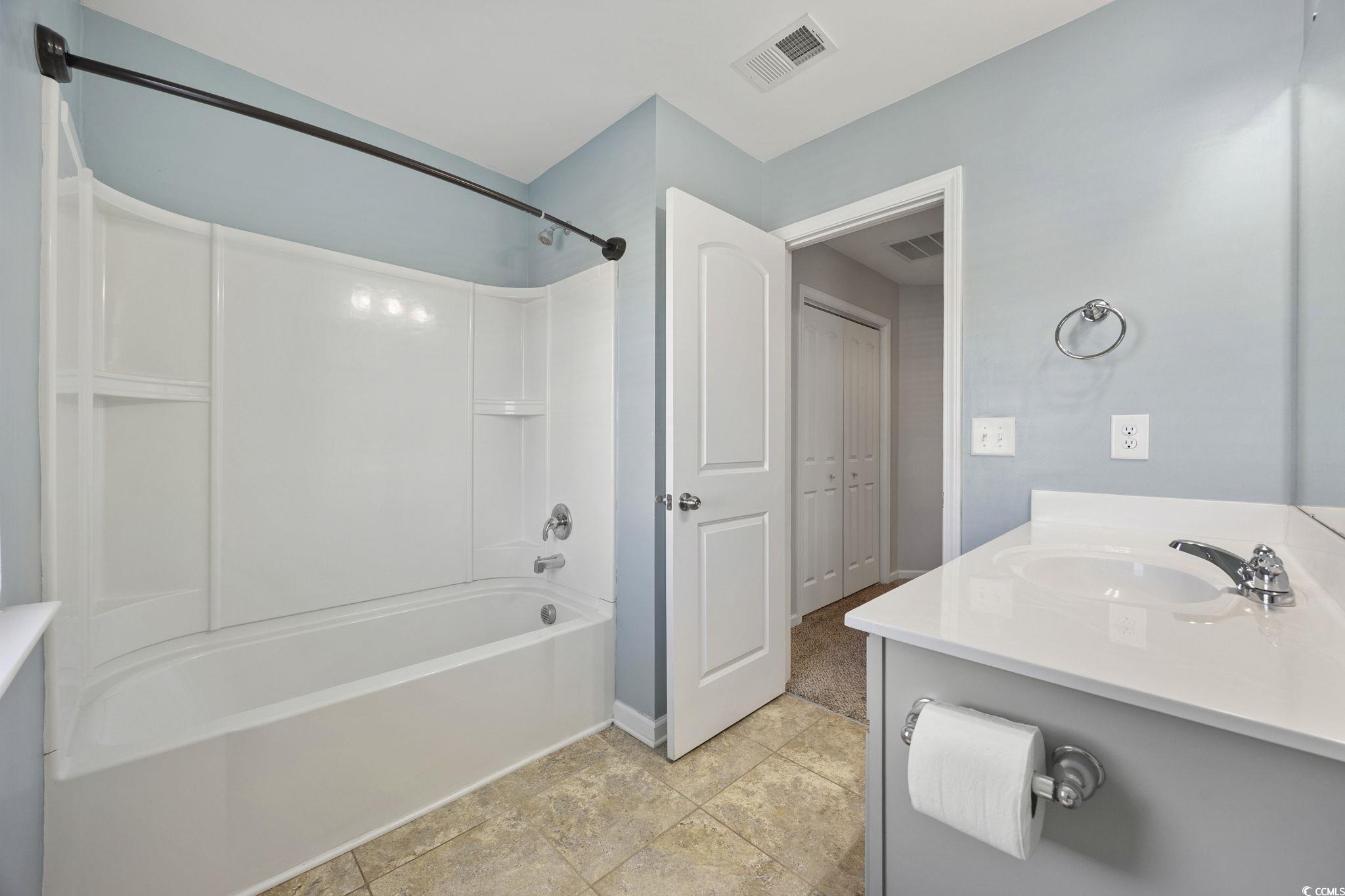 115 Machrie Loop, Unit D Myrtle Beach, SC 29588 - Photo 30 of 40 Full bath with vanity, tub / shower combination, and light tile patterned flooring