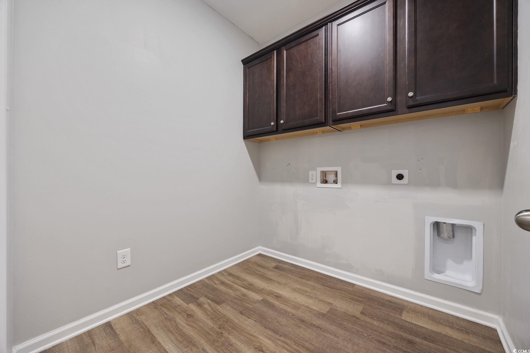 115 Machrie Loop, Unit D Myrtle Beach, SC 29588 - Photo 31 of 40 Laundry room featuring cabinet space, wood finished floors, hookup for a washing machine, and hookup for an electric dryer
