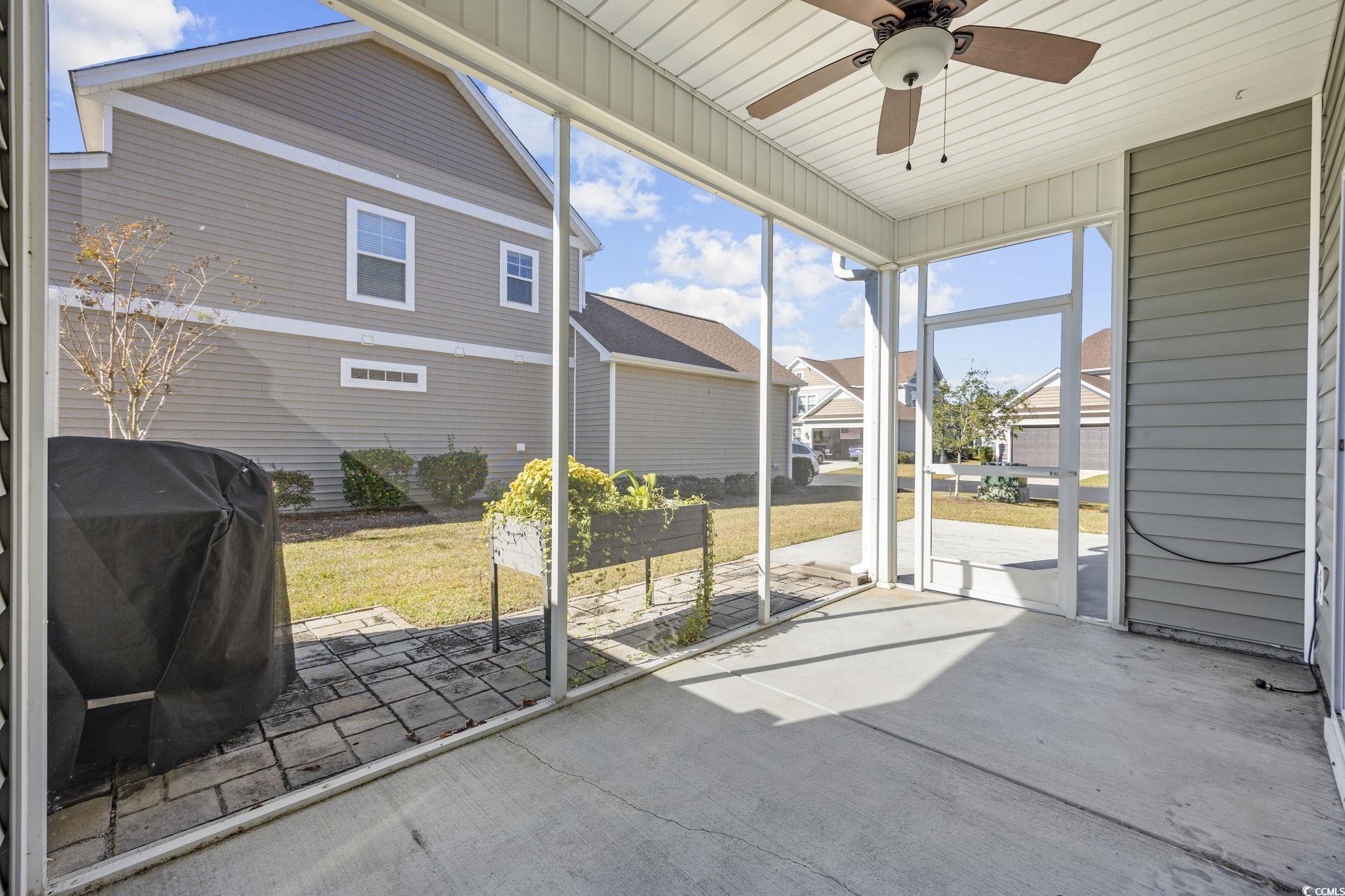 115 Machrie Loop, Unit D Myrtle Beach, SC 29588 - Photo 32 of 40 Unfurnished sunroom with a ceiling fan and a patio area
