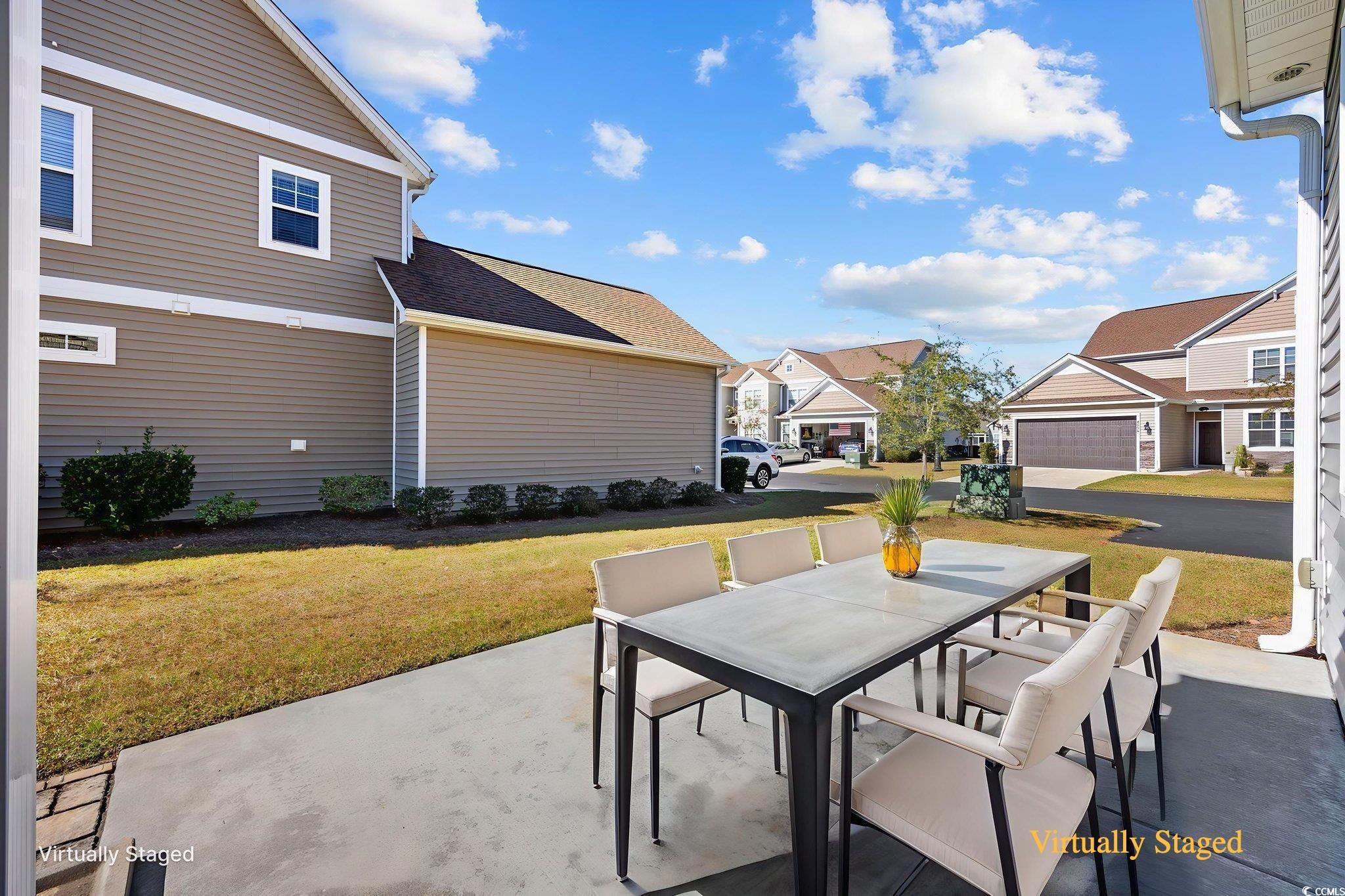 115 Machrie Loop, Unit D Myrtle Beach, SC 29588 - Photo 33 of 40 View of patio / terrace featuring outdoor dining space, a residential view, and grilling area
