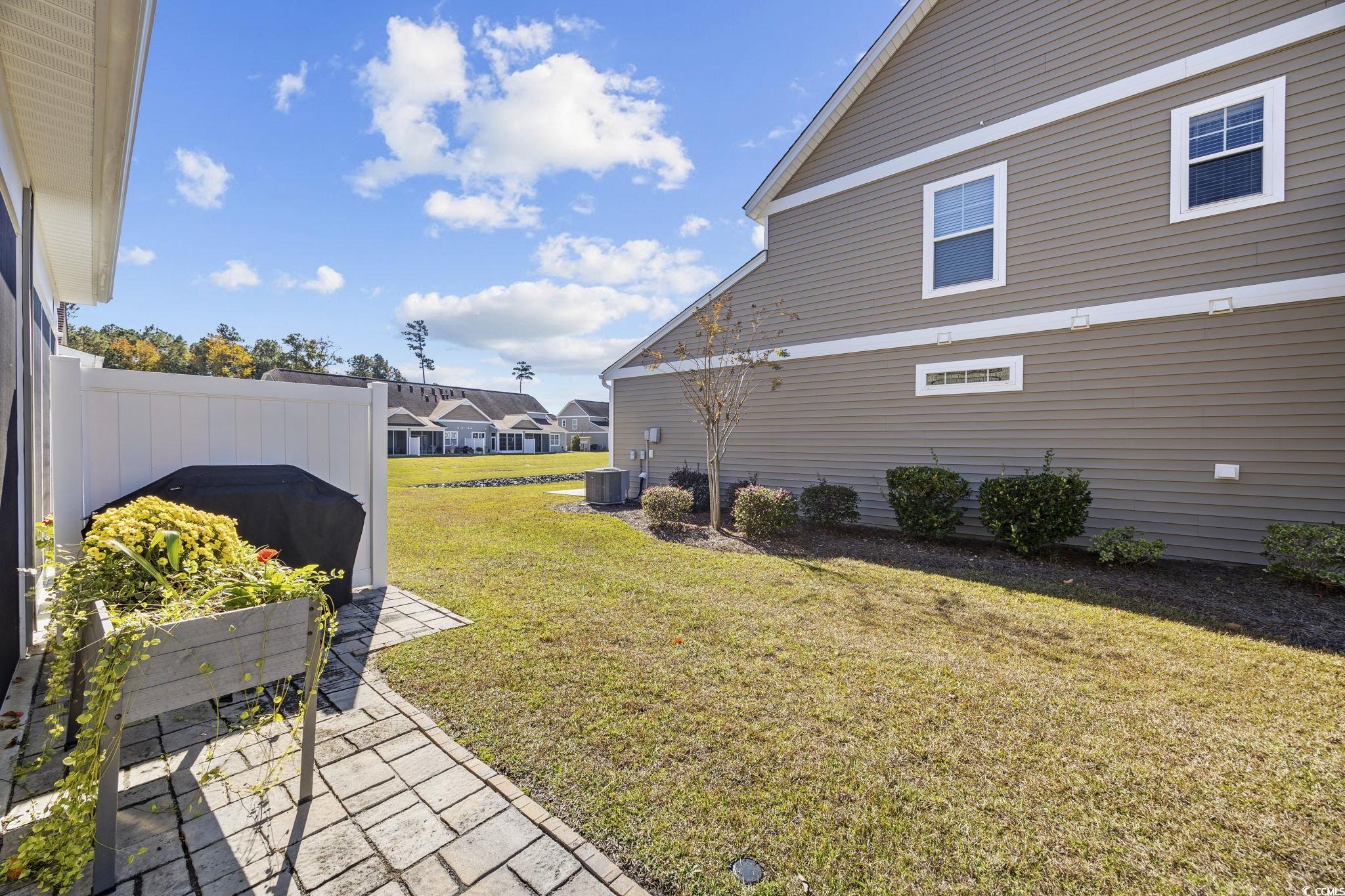 115 Machrie Loop, Unit D Myrtle Beach, SC 29588 - Photo 34 of 40 View of green lawn featuring a patio area