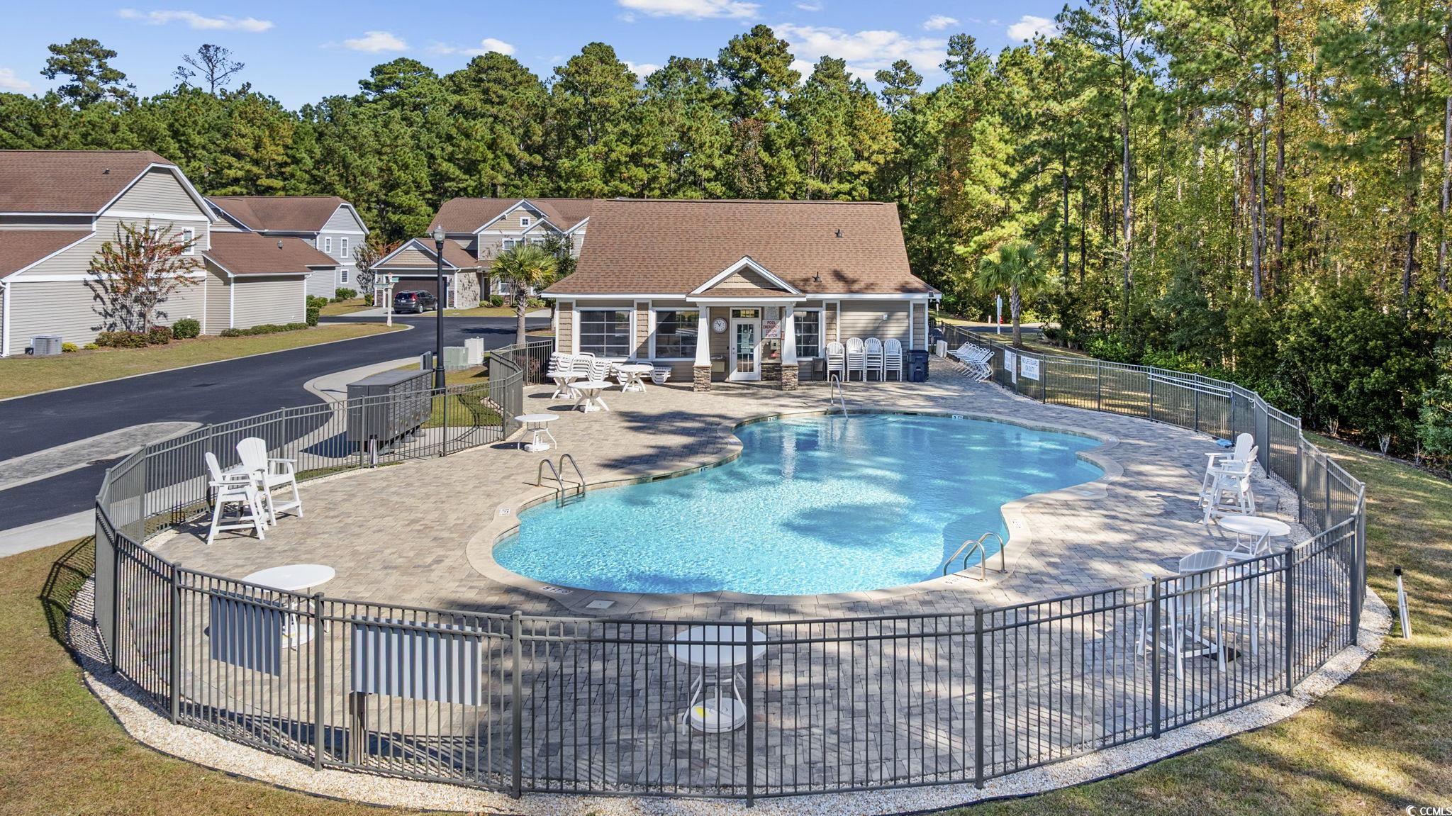 115 Machrie Loop, Unit D Myrtle Beach, SC 29588 - Photo 38 of 40 Community pool featuring a patio and an outbuilding