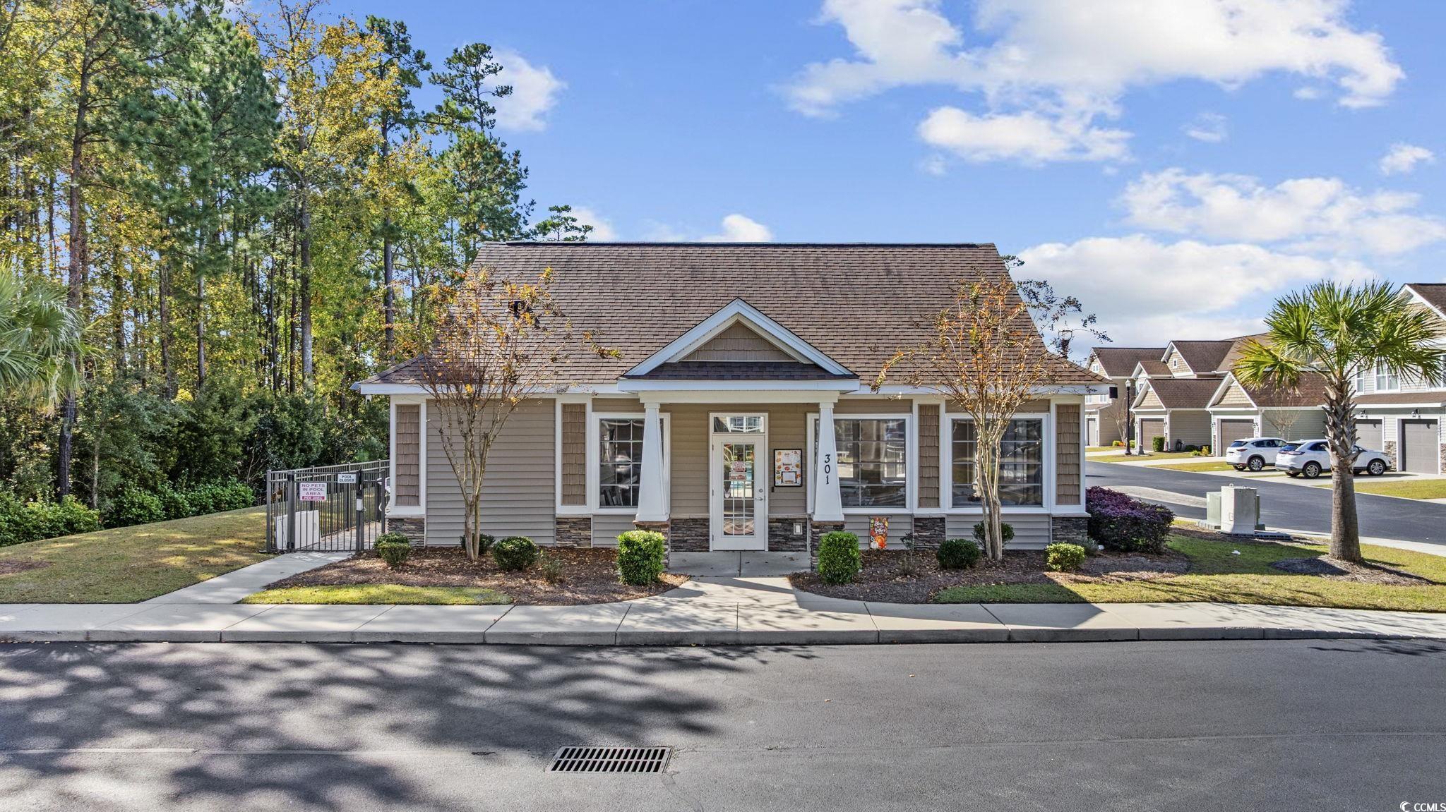 115 Machrie Loop, Unit D Myrtle Beach, SC 29588 - Photo 39 of 40 View of front of property featuring a shingled roof, a gate, a porch, and stone siding