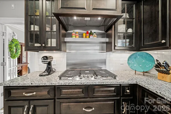 a kitchen with a stove a sink and a microwave