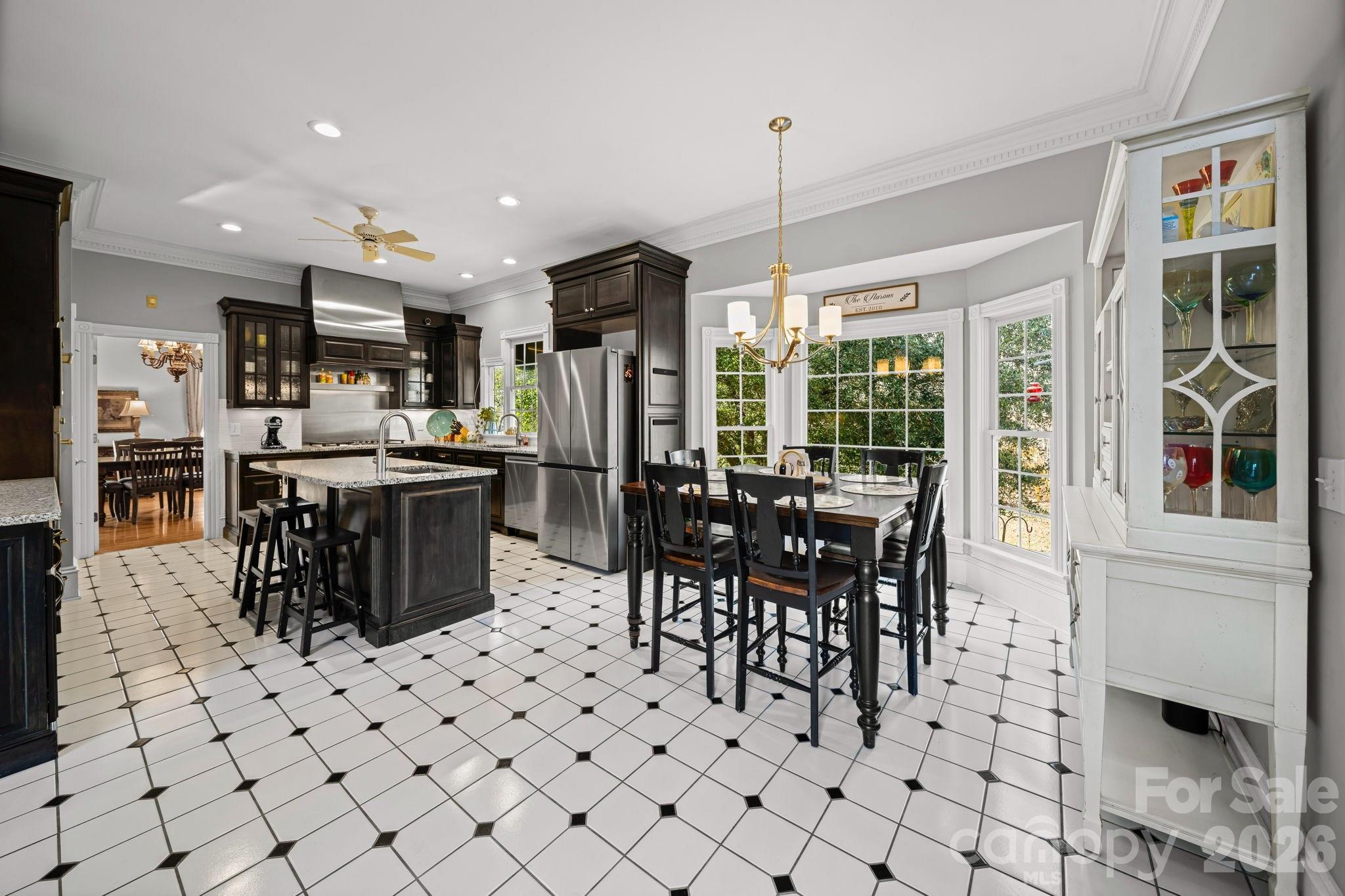 32618 Guard Road Albemarle, NC 28001 - Photo 18 of 48 a kitchen with stainless steel appliances kitchen island granite countertop a stove a refrigerator a dining table and chairs