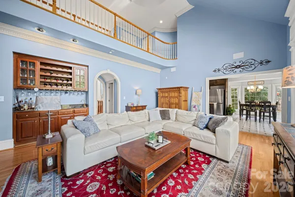 a work room with furniture or chandelier and a wooden floor