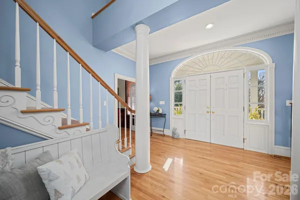 a view of entryway and hall with wooden floor