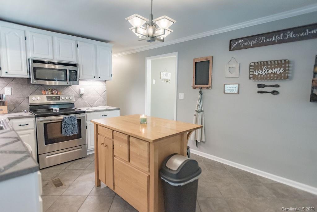 2519 Old Camden Road Monroe, NC 28110 - Photo 11 of 42 a kitchen with a stove and a sink