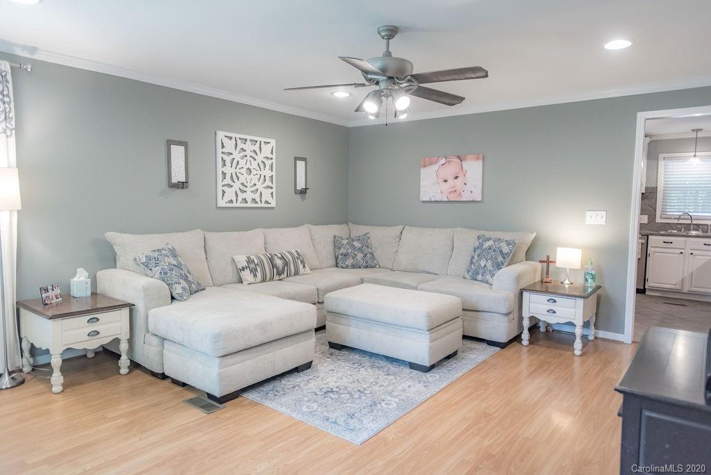 2519 Old Camden Road Monroe, NC 28110 - Photo 15 of 42 a living room with furniture and a chandelier