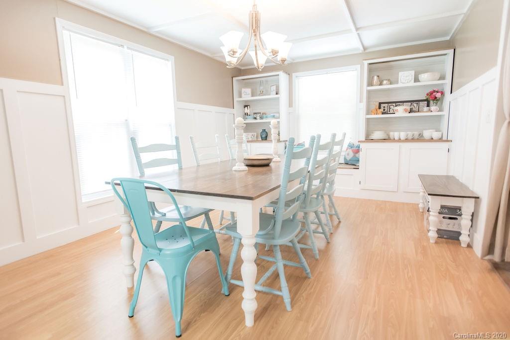 2519 Old Camden Road Monroe, NC 28110 - Photo 19 of 42 a view of a dining room with furniture and wooden floor