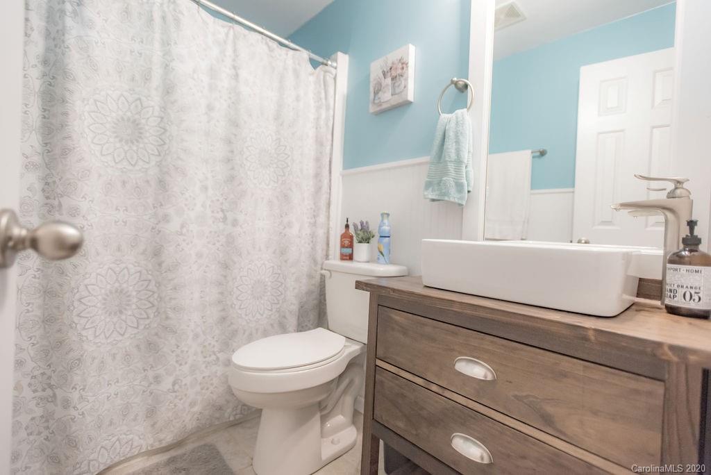 2519 Old Camden Road Monroe, NC 28110 - Photo 22 of 42 a bathroom with a sink a toilet and shower curtain