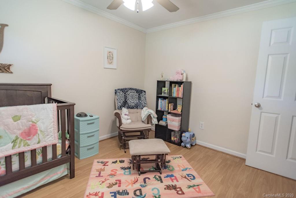 2519 Old Camden Road Monroe, NC 28110 - Photo 26 of 42 a bedroom with furniture and a book shelf