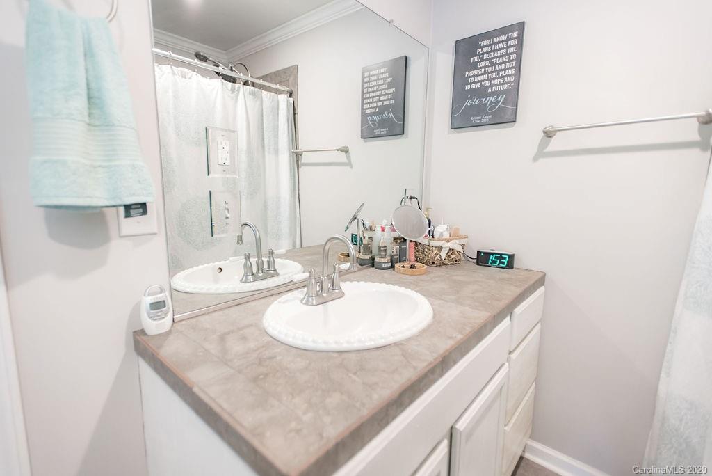 2519 Old Camden Road Monroe, NC 28110 - Photo 29 of 42 a bathroom with a sink and a mirror