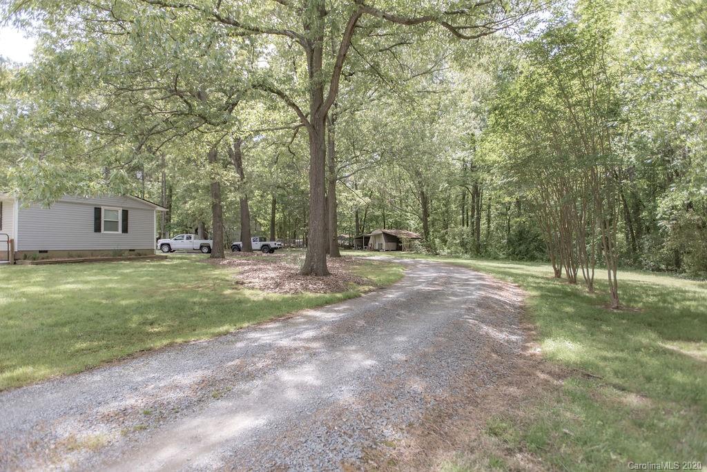 2519 Old Camden Road Monroe, NC 28110 - Photo 37 of 42 a view of a house with a big yard and large trees