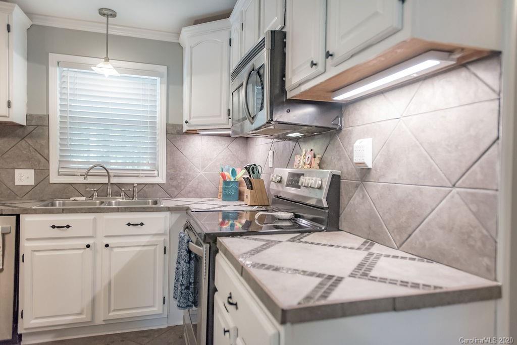 2519 Old Camden Road Monroe, NC 28110 - Photo 10 of 42 a kitchen with stainless steel appliances granite countertop a sink a stove and cabinets