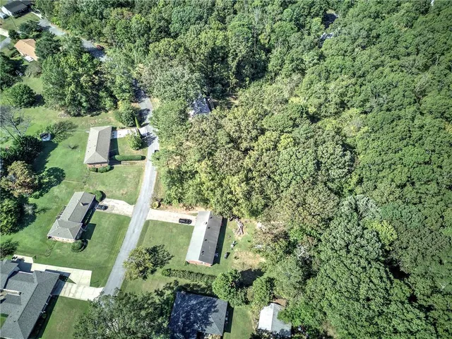 an aerial view of a house with yard