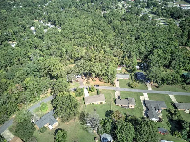 an aerial view of residential house with outdoor space and trees around