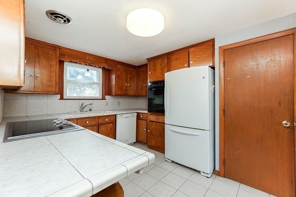 4 Pico Avenue Winthrop, MA 02152 - Photo 11 of 42 a kitchen with stainless steel appliances granite countertop a refrigerator sink and cabinets