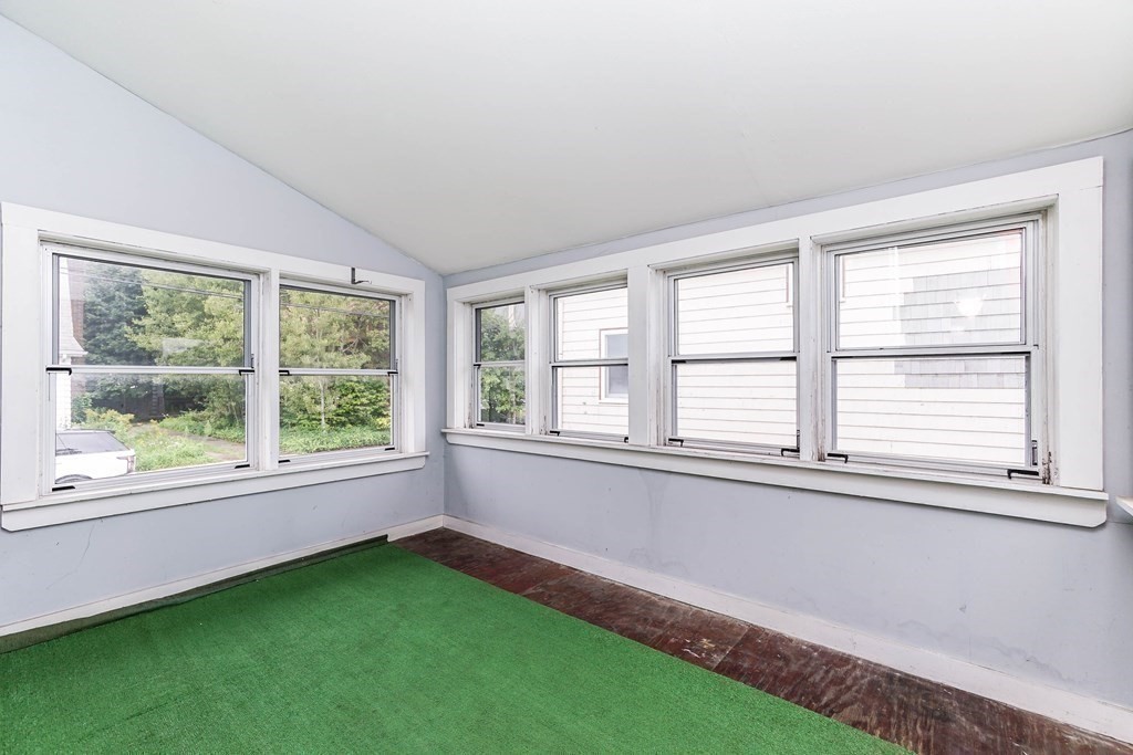 4 Pico Avenue Winthrop, MA 02152 - Photo 13 of 42 a view of an empty room with a window and a kitchen