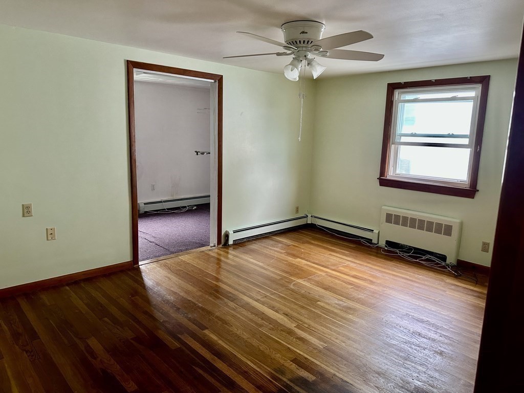 4 Pico Avenue Winthrop, MA 02152 - Photo 29 of 42 an empty room with wooden floor chandelier fan and windows