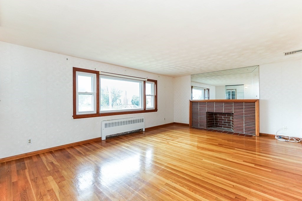4 Pico Avenue Winthrop, MA 02152 - Photo 6 of 42 an empty room with wooden floor and windows