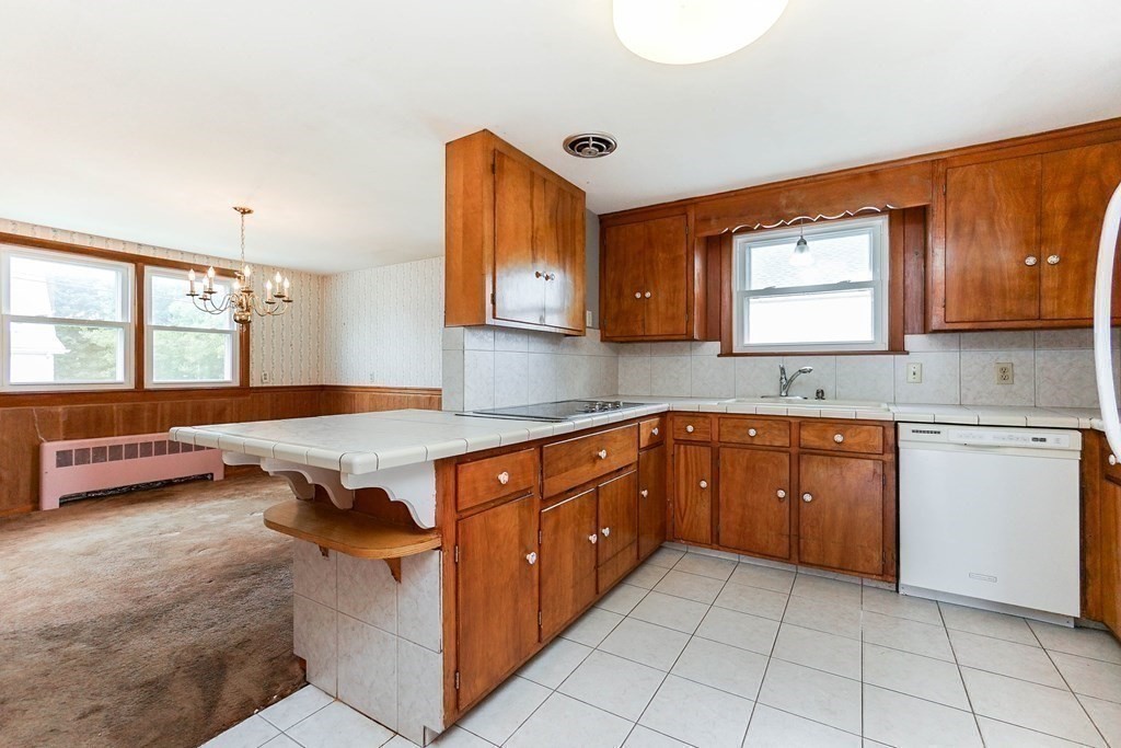 4 Pico Avenue Winthrop, MA 02152 - Photo 8 of 42 a kitchen with stainless steel appliances granite countertop a sink and cabinets