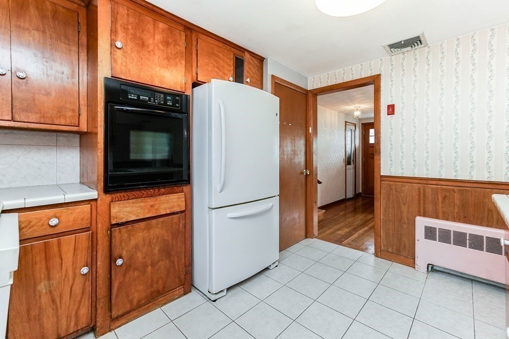 4 Pico Avenue Winthrop, MA 02152 - Photo 10 of 42 a kitchen with stainless steel appliances granite countertop a refrigerator and a stove top oven