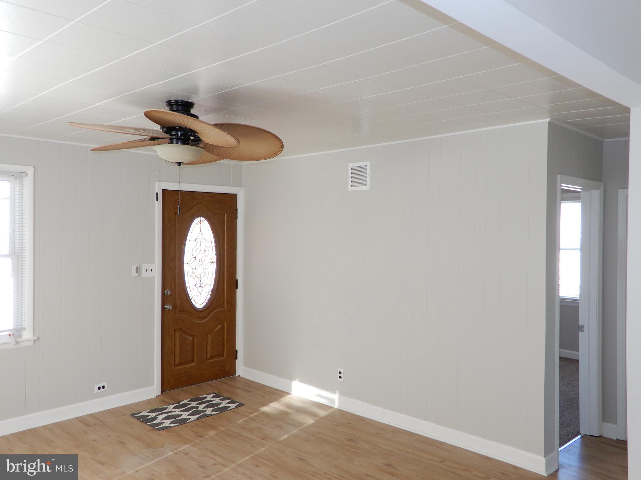 7606 Poplar Road Baltimore, MD 21222 - Photo 6 of 18 a view of a livingroom with wooden floor and window