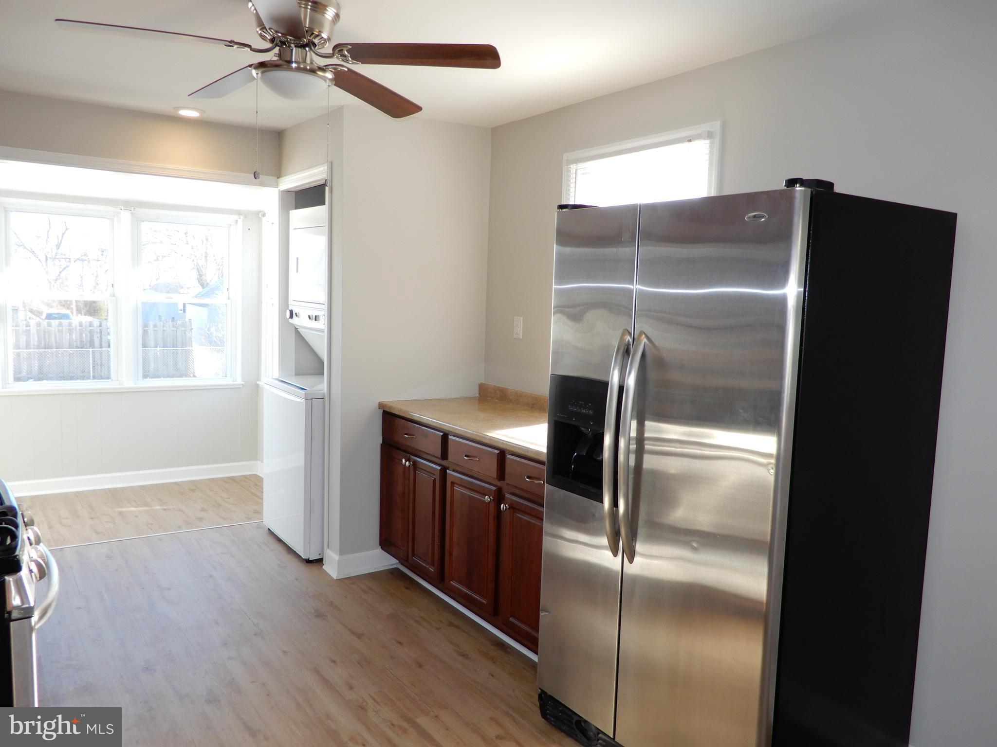 7606 Poplar Road Baltimore, MD 21222 - Photo 9 of 18 a metallic refrigerator freezer sitting in a kitchen