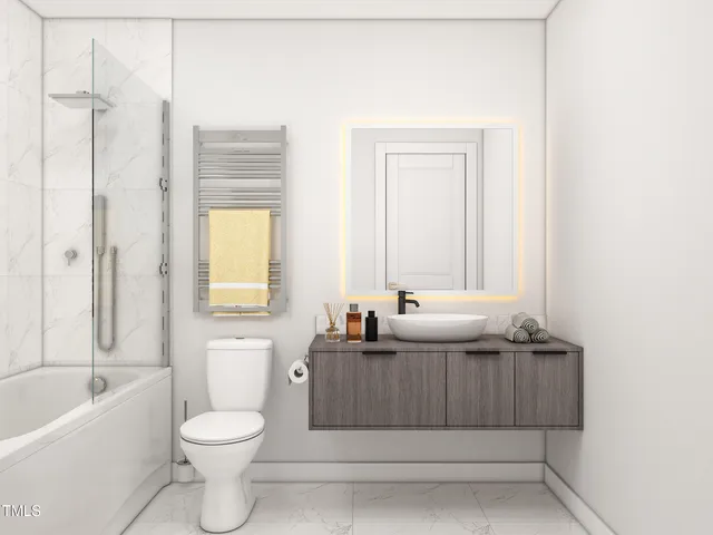 a bathroom with a granite countertop sink a toilet and shower