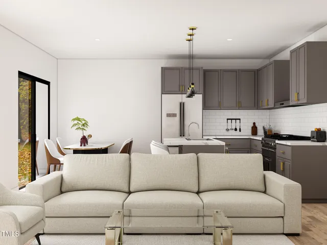 a living room with furniture kitchen view and a window