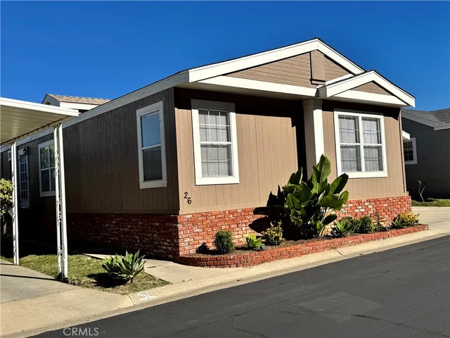 a front view of a house with a garden