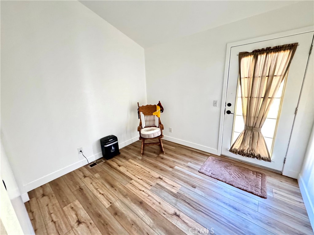 23301 Ridge Rte Drive, Unit 26 Laguna Hills, CA 92653 - Photo 13 of 16 a room with wooden floor and gym equipment