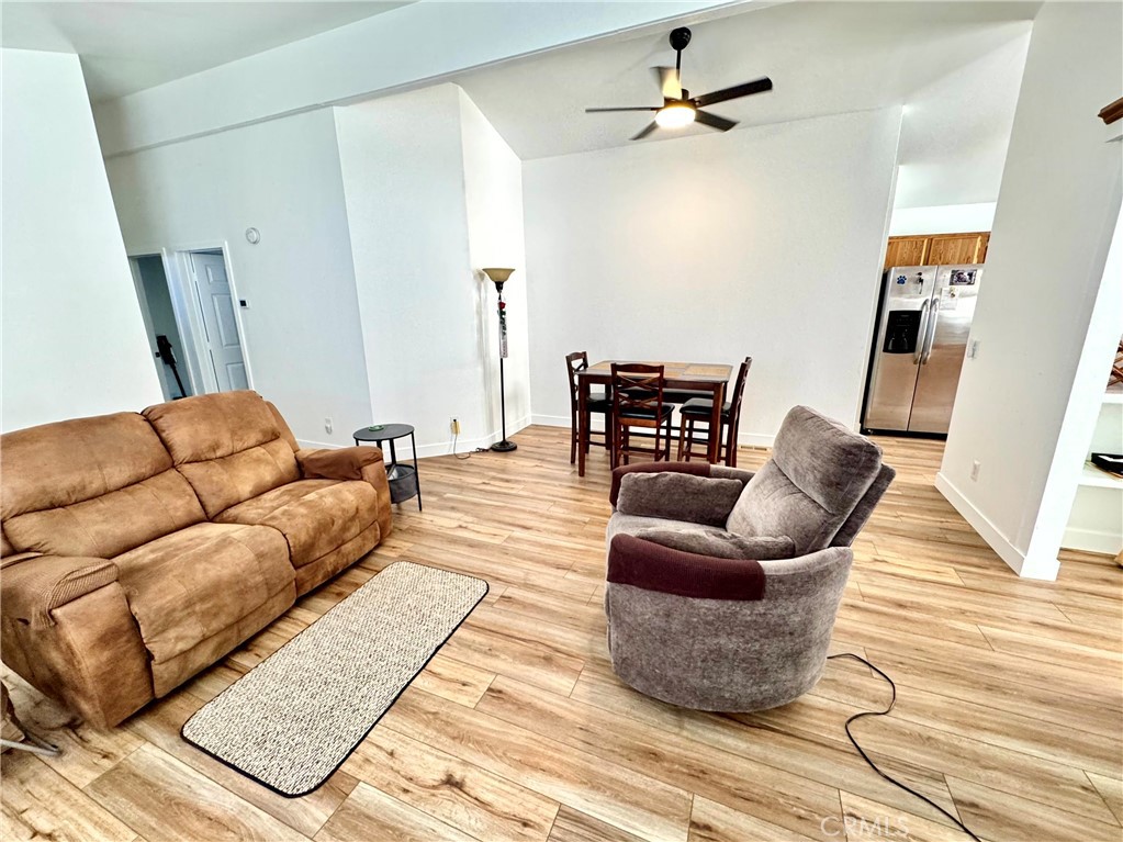 23301 Ridge Rte Drive, Unit 26 Laguna Hills, CA 92653 - Photo 4 of 16 a living room with furniture rug and wooden floor