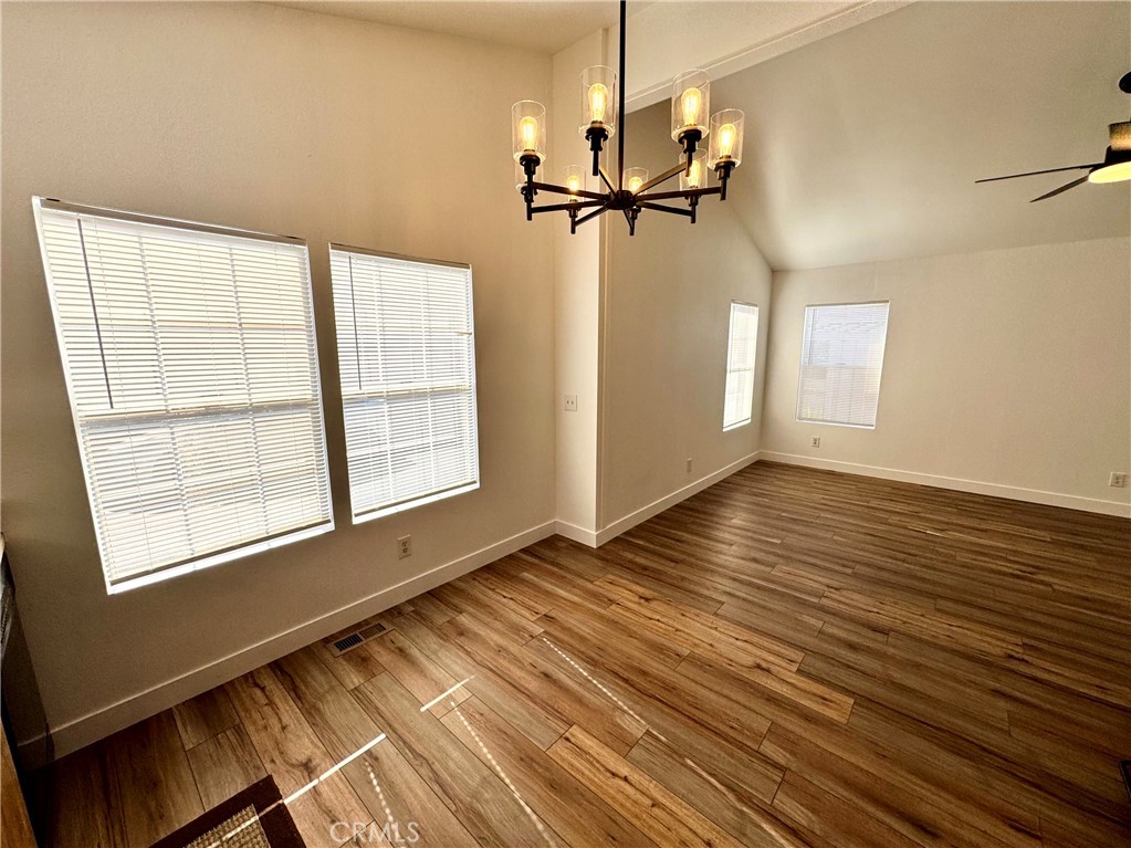 23301 Ridge Rte Drive, Unit 26 Laguna Hills, CA 92653 - Photo 8 of 16 an empty room with wooden floor closet and windows