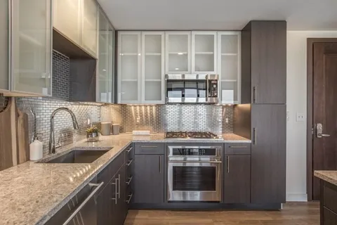 a kitchen with stainless steel appliances granite countertop a stove and a sink
