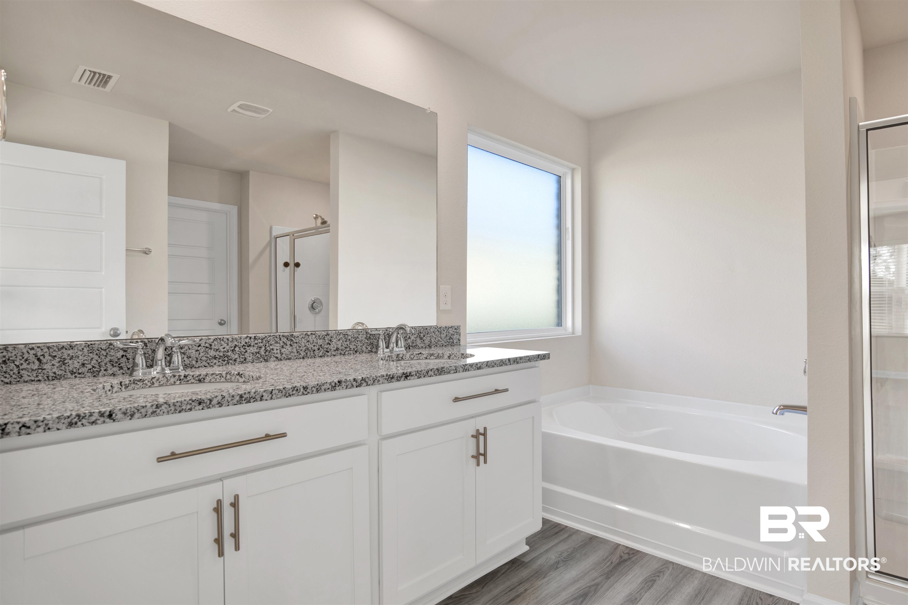 32038 Lyon Road Daphne, AL 36527 - Photo 17 of 30 Bathroom with a stall shower, double vanity, a bath, and dark wood-style flooring