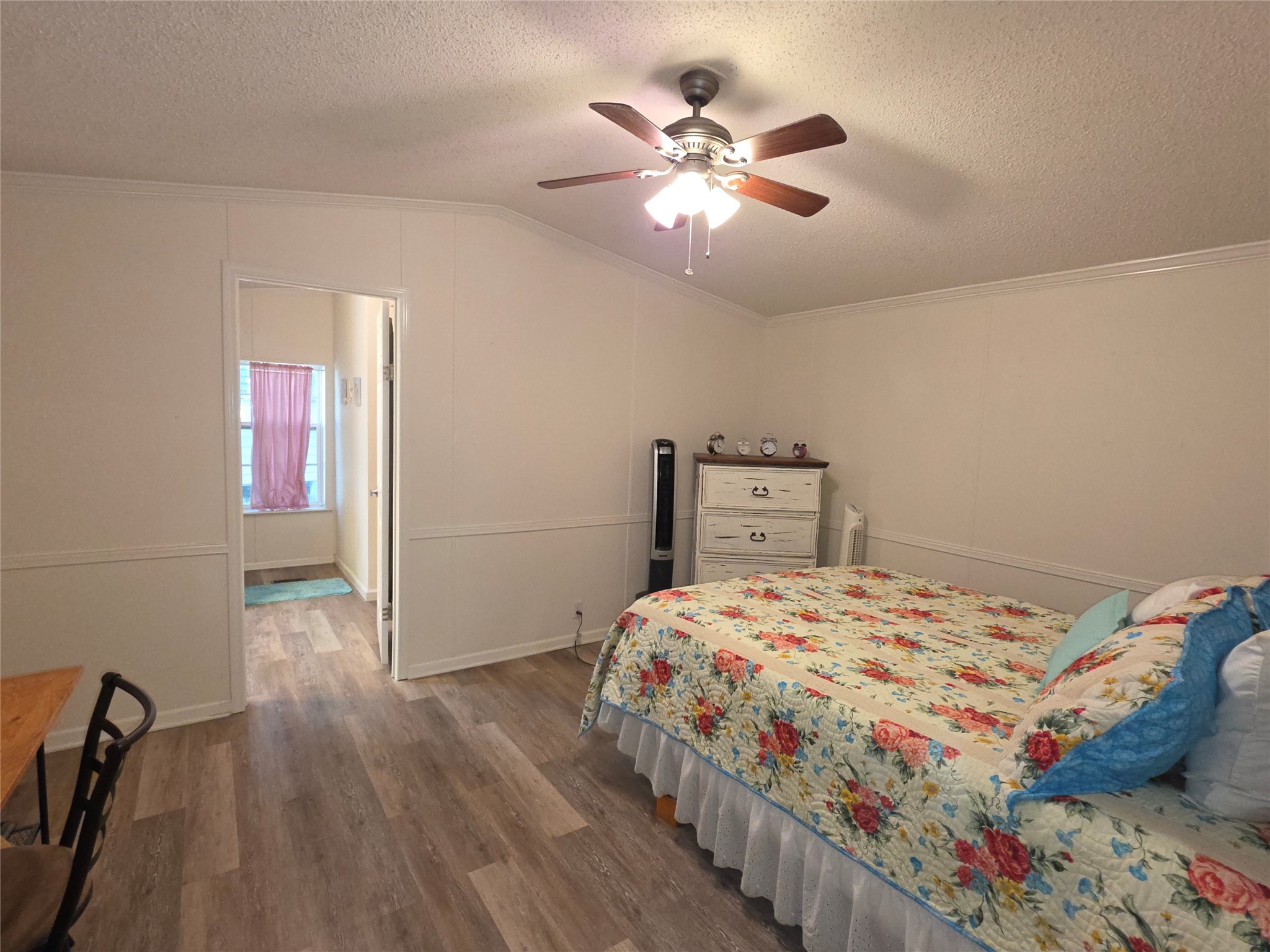 70 Montego Way Point Blank, TX 77364 - Photo 10 of 41 a bedroom with a bed and a chandelier