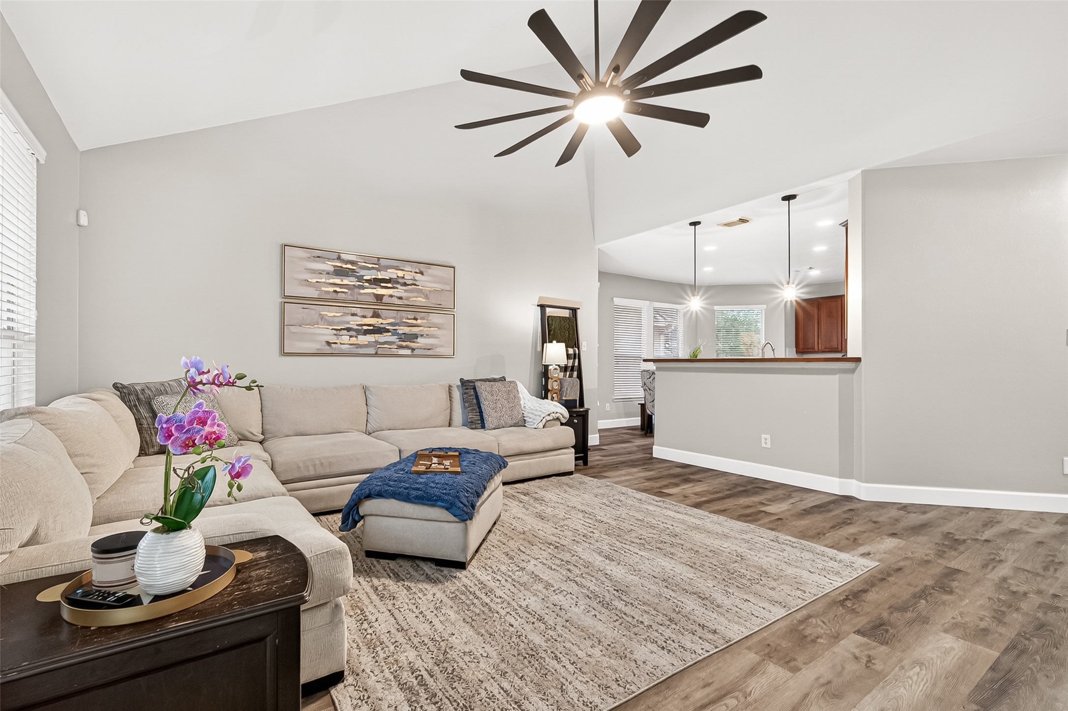 7415 Riven Oaks Court Cypress, TX 77433 - Photo 1 of 42 This view showcases the upgraded oversized ceiling fan and beautifully updated butcher block breakfast bar, adding both style and functionality to the open living space.