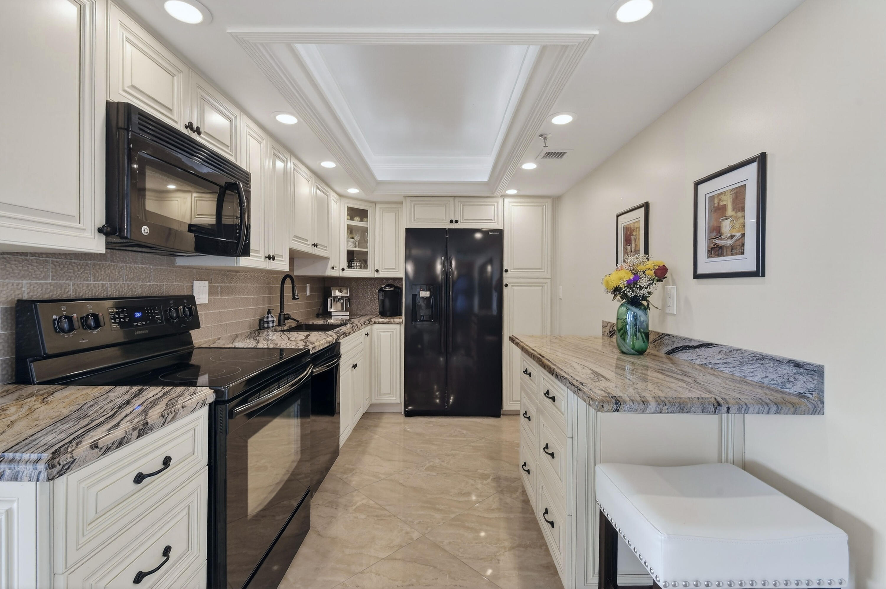 1300 Florida A1A, Unit 320 Jupiter, FL 33477 - Photo 16 of 92 a kitchen with stainless steel appliances granite countertop a refrigerator a stove a sink a microwave and a refrigerator