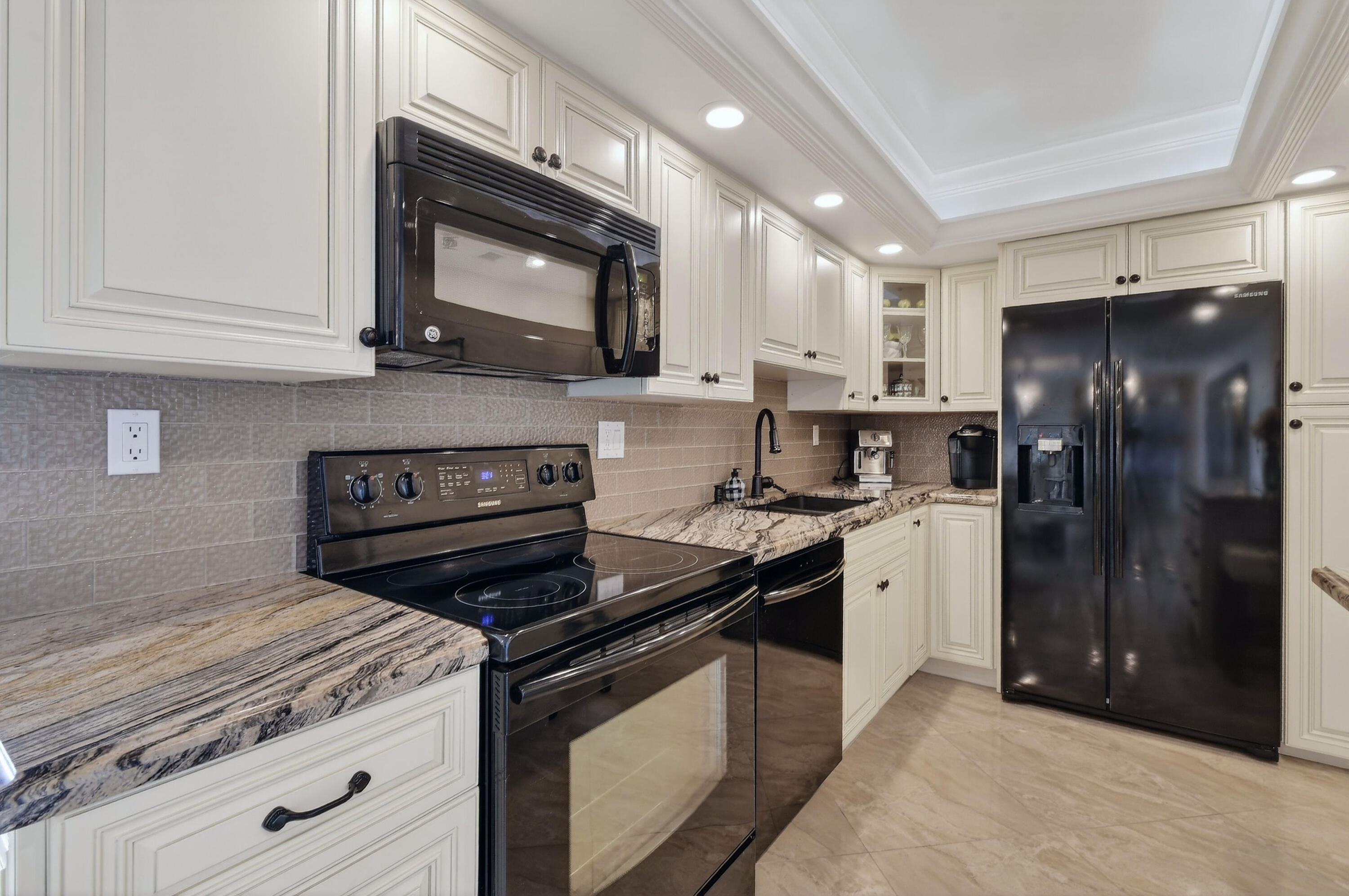 1300 Florida A1A, Unit 320 Jupiter, FL 33477 - Photo 18 of 92 a kitchen with a stove microwave and refrigerator